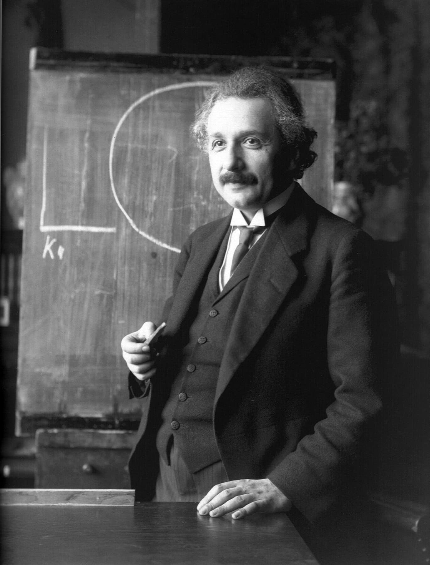 Albert Einstein standing beside a chalkboard during a lecture in Vienna in 1921